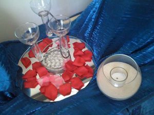 A rose centerpiece on blue linen used for a catering event in Columbus OH