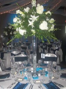 a green plant with white flowers in a glass vase used for a catered wedding event in Columbus OH