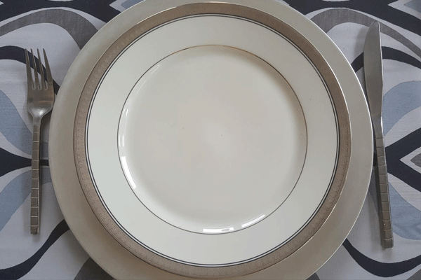 catering plates and silverware with metallic trim