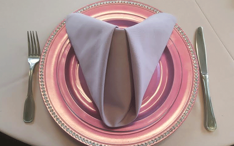 a pink metallic plate and lavender napkin for catering